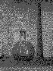 A dithered photograph of a round glass bottle with a tall stopper, standing on a shelf